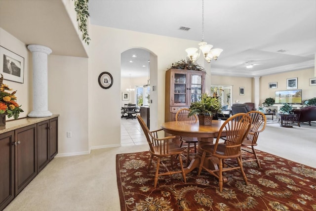 dining area with light colored carpet and an inviting chandelier