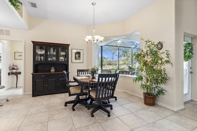 dining space featuring light tile patterned flooring and a chandelier