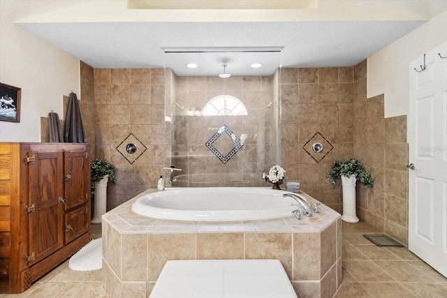 bathroom featuring tile patterned flooring, tile walls, and independent shower and bath