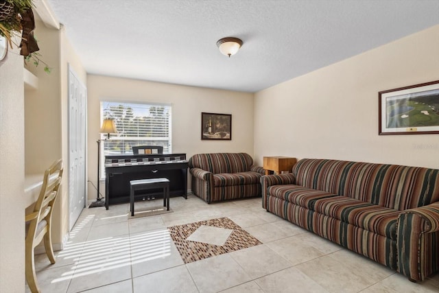 living room with light tile patterned floors and a textured ceiling