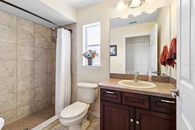 bathroom featuring a shower with shower curtain, vanity, toilet, and tile patterned flooring