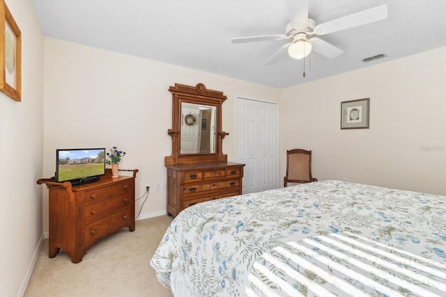 carpeted bedroom featuring a closet and ceiling fan