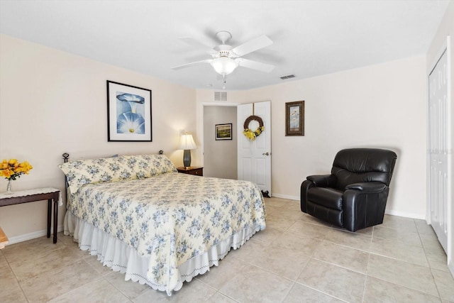 bedroom featuring light tile patterned floors, a closet, and ceiling fan