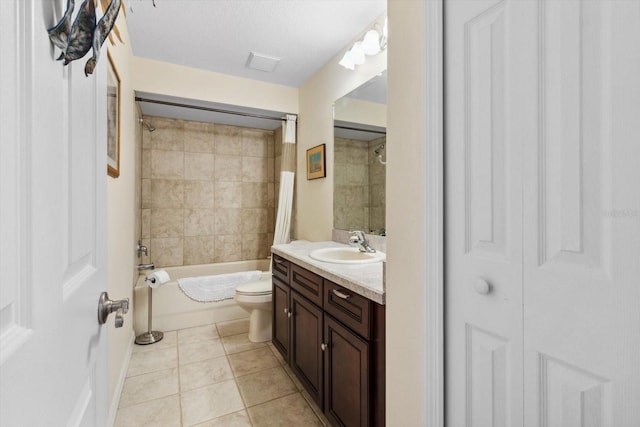 full bathroom featuring tile patterned floors, vanity, toilet, and tiled shower / bath