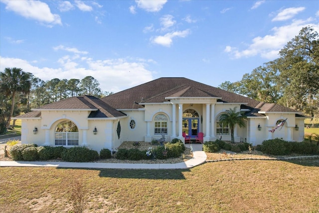 view of front of house featuring french doors and a front lawn