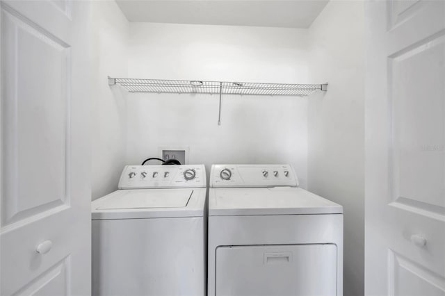 laundry area with independent washer and dryer