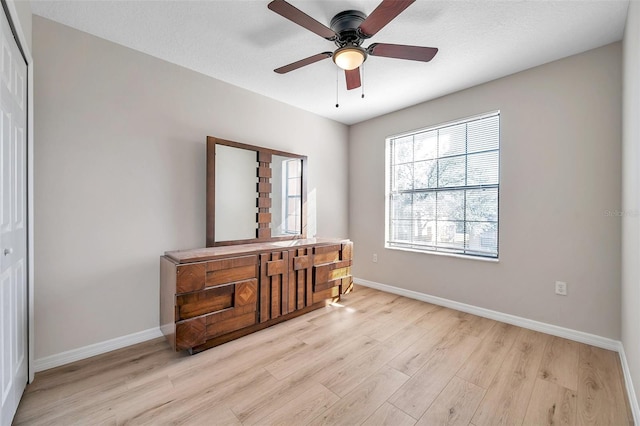 bedroom featuring ceiling fan, light hardwood / wood-style floors, and a closet