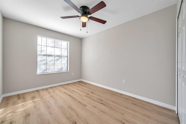 empty room featuring ceiling fan and light hardwood / wood-style flooring