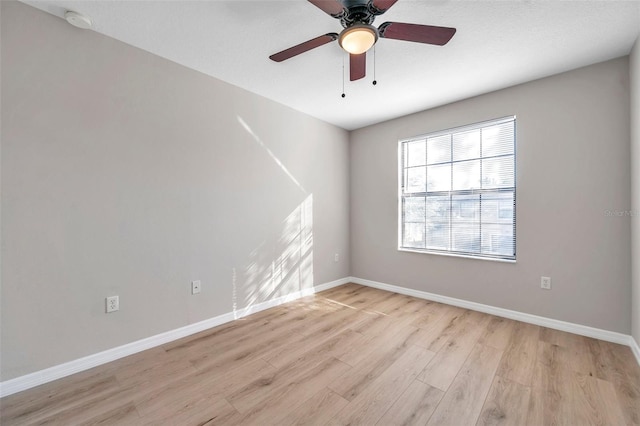 spare room with light wood-type flooring and ceiling fan