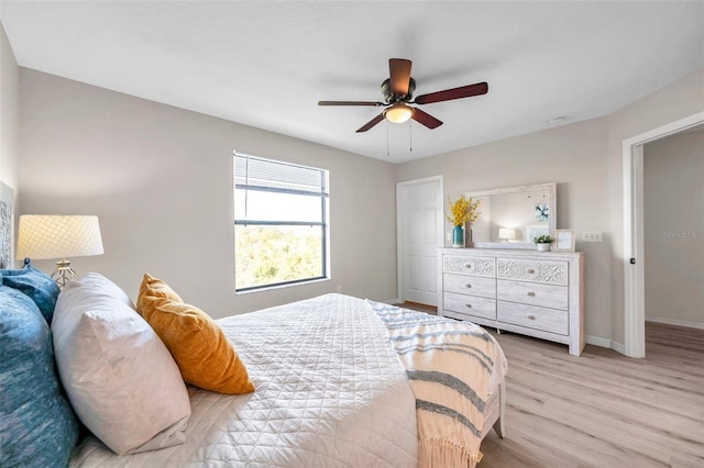 bedroom with ceiling fan and light hardwood / wood-style floors