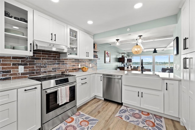 kitchen featuring stainless steel appliances, sink, white cabinets, and light hardwood / wood-style flooring