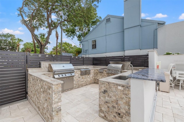 view of patio / terrace with area for grilling, exterior kitchen, and sink