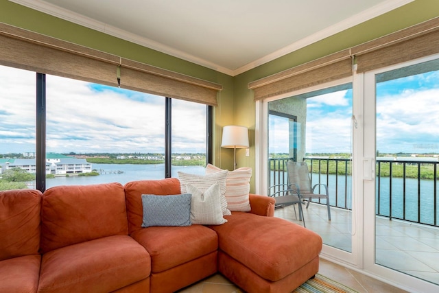 living room with a water view, crown molding, and light tile patterned floors