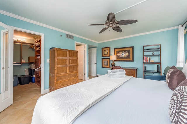 bedroom with a walk in closet, ornamental molding, a closet, and light tile patterned floors