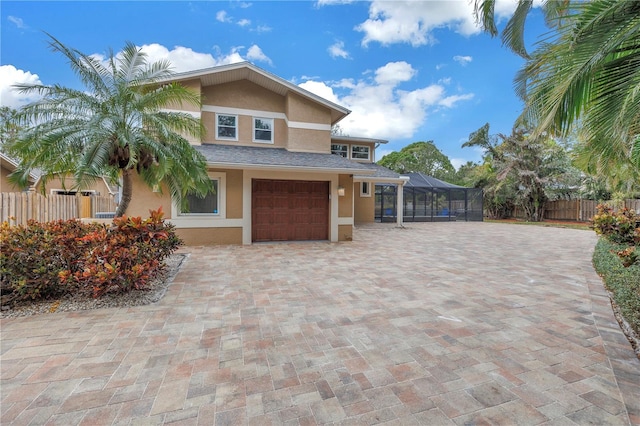 view of front of house featuring glass enclosure and a garage