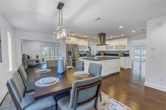 dining space featuring plenty of natural light and dark hardwood / wood-style floors