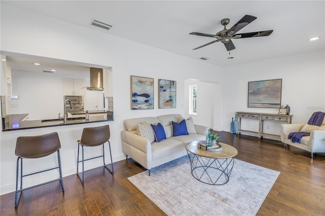 living room with ceiling fan, dark wood-type flooring, and sink