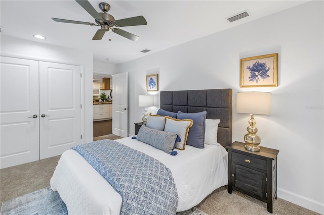 bedroom featuring ceiling fan, a closet, and light carpet