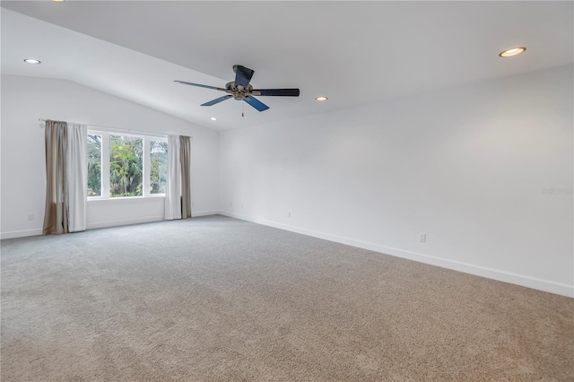 spare room with ceiling fan, carpet flooring, and lofted ceiling