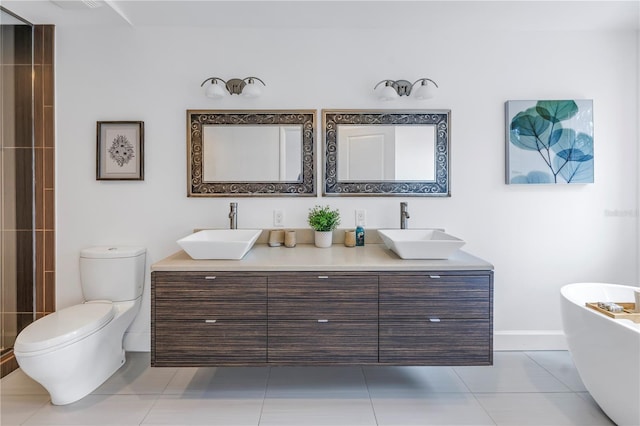 bathroom with toilet, tile patterned flooring, a tub to relax in, and vanity