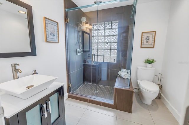 bathroom with toilet, a shower with door, vanity, and tile patterned flooring