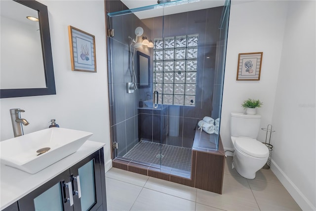 bathroom with a shower with shower door, toilet, vanity, and tile patterned flooring