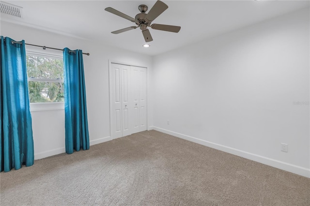 empty room with ceiling fan and carpet flooring