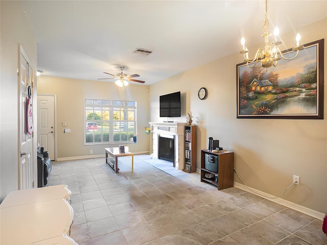 living room featuring ceiling fan with notable chandelier