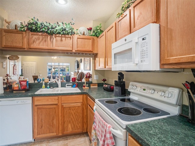 kitchen featuring white appliances and sink