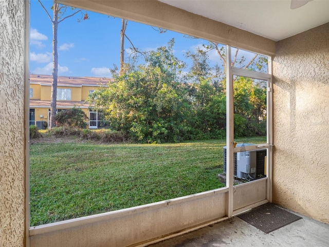 unfurnished sunroom with ceiling fan