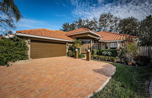 mediterranean / spanish-style house with a garage