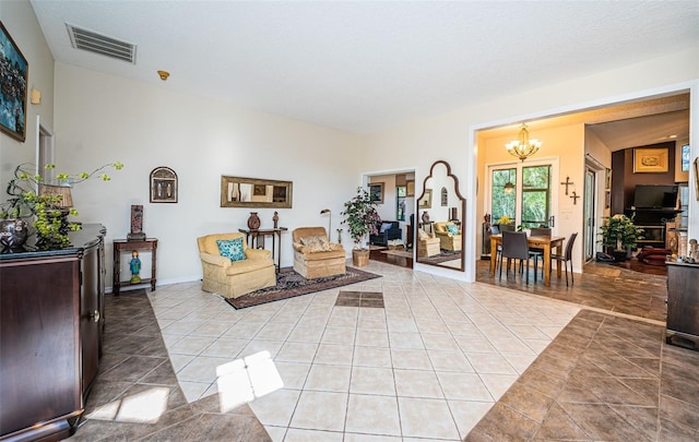 living room featuring an inviting chandelier and light tile patterned floors