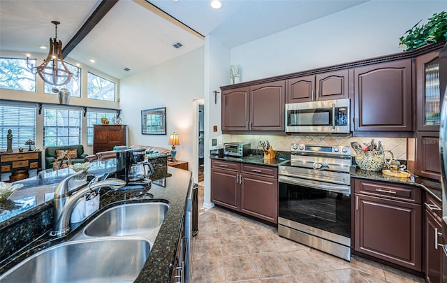 kitchen with pendant lighting, sink, decorative backsplash, stainless steel appliances, and beam ceiling