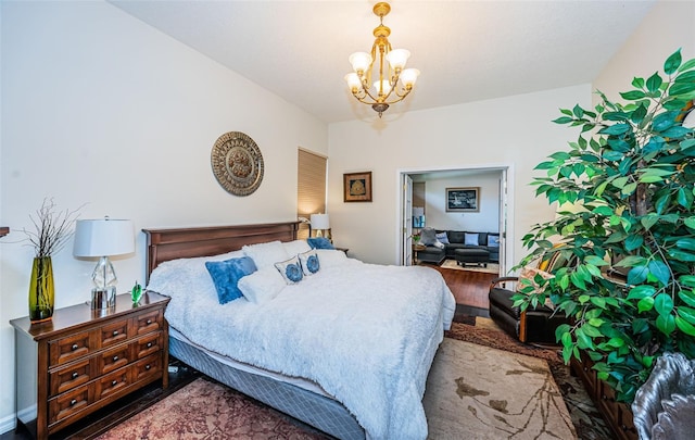 bedroom featuring wood-type flooring and an inviting chandelier