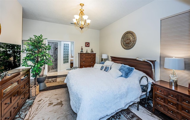 bedroom featuring a textured ceiling and a chandelier