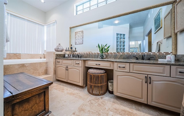 bathroom featuring vanity and a relaxing tiled tub