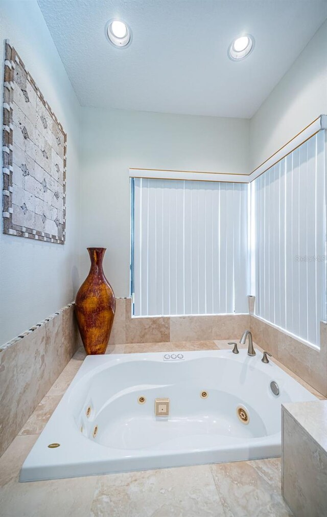 bathroom featuring tiled tub