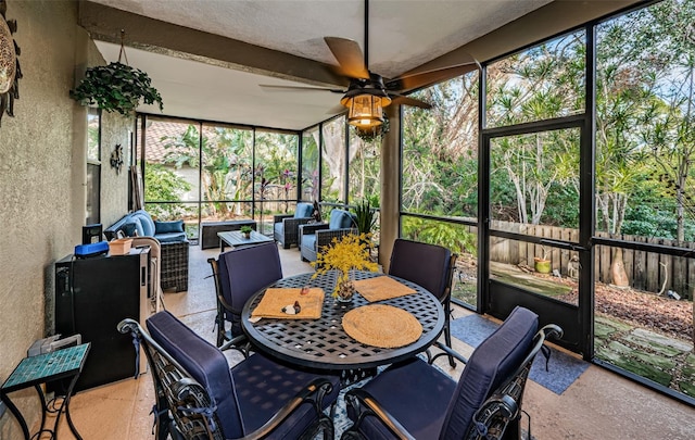 sunroom featuring ceiling fan and plenty of natural light