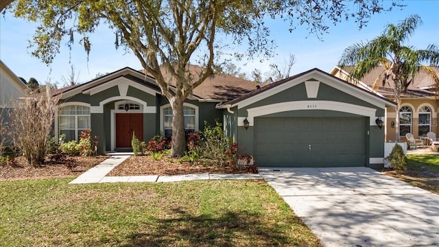 ranch-style house with a garage, driveway, a front yard, and stucco siding