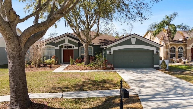 single story home with driveway, a front yard, an attached garage, and stucco siding