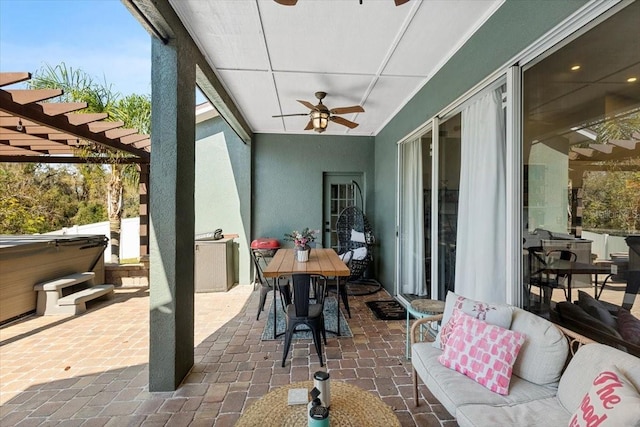 sunroom featuring a ceiling fan and a healthy amount of sunlight