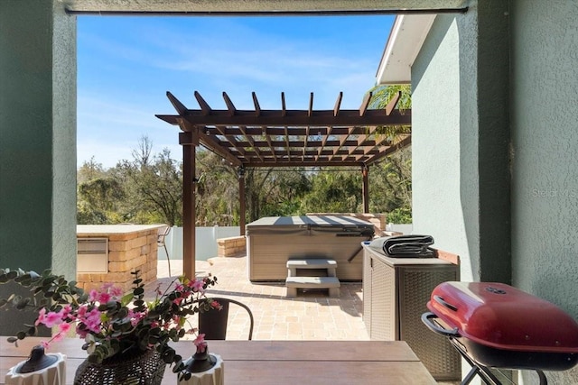 view of patio featuring a grill, fence, a hot tub, and a pergola