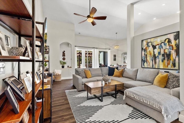 living area with high vaulted ceiling, a ceiling fan, baseboards, and wood finished floors