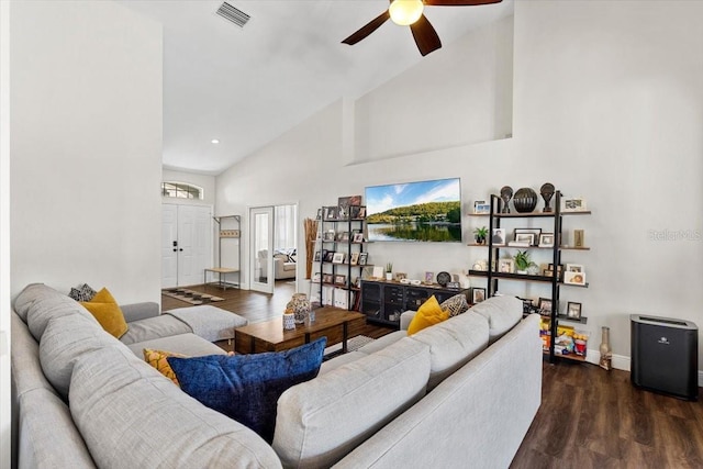 living room with high vaulted ceiling, wood finished floors, visible vents, baseboards, and a ceiling fan