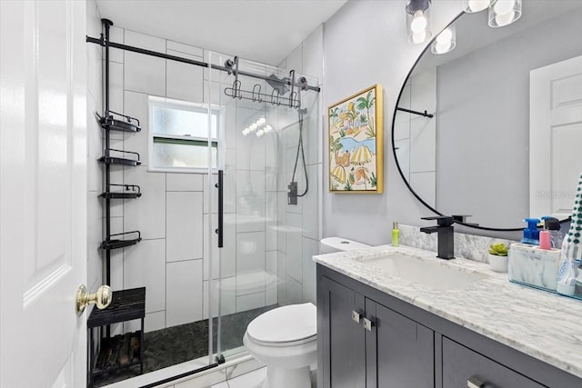 bathroom featuring toilet, marble finish floor, a shower stall, and vanity