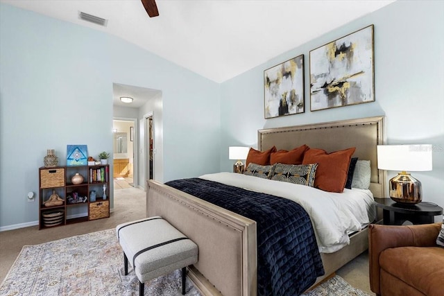 carpeted bedroom with baseboards, visible vents, connected bathroom, ceiling fan, and vaulted ceiling