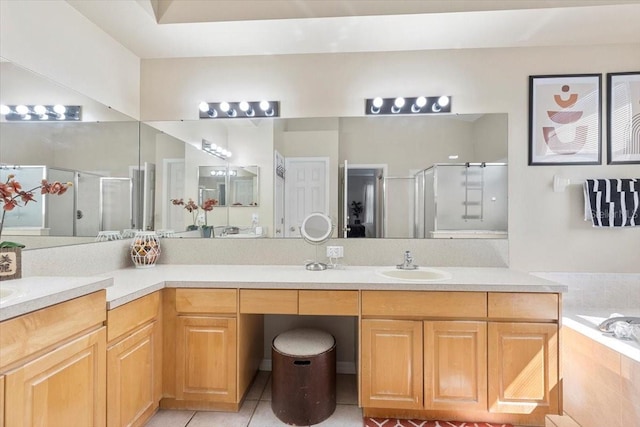 bathroom featuring a garden tub, tile patterned flooring, a shower stall, and vanity