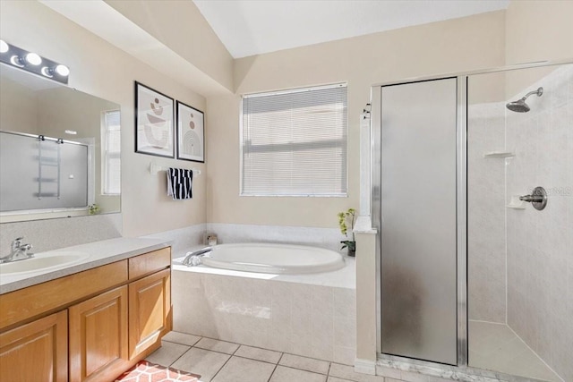 bathroom with a healthy amount of sunlight, a shower stall, vanity, tile patterned flooring, and a bath