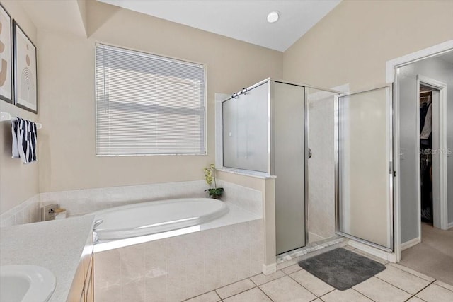 bathroom with a stall shower, tile patterned flooring, and a bath