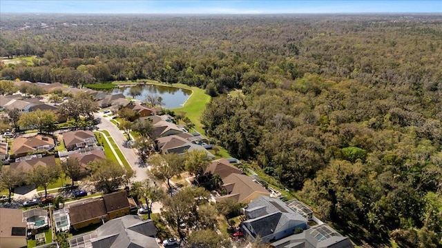 birds eye view of property featuring a residential view, a water view, and a wooded view